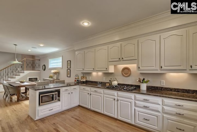 12 Club Ridge Ct, Elgin, SC 29045 - kitchen with stainless steel appliances, kitchen peninsula, white cabinets, hanging light fixtures, and light wood-type flooring