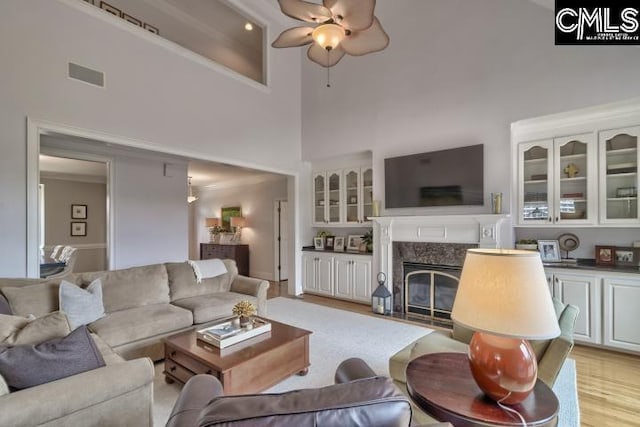 12 Club Ridge Ct, Elgin, SC 29045 - living room with a high end fireplace, a high ceiling, ceiling fan, and light wood-type flooring