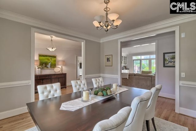12 Club Ridge Ct, Elgin, SC 29045 - dining area with light wood-type flooring, ornamental molding, and a chandelier