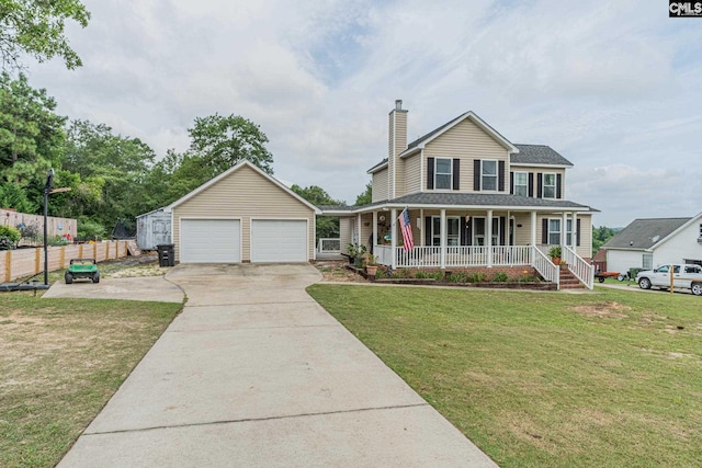 view of front of property with a porch, a front lawn, an outdoor structure, and a garage