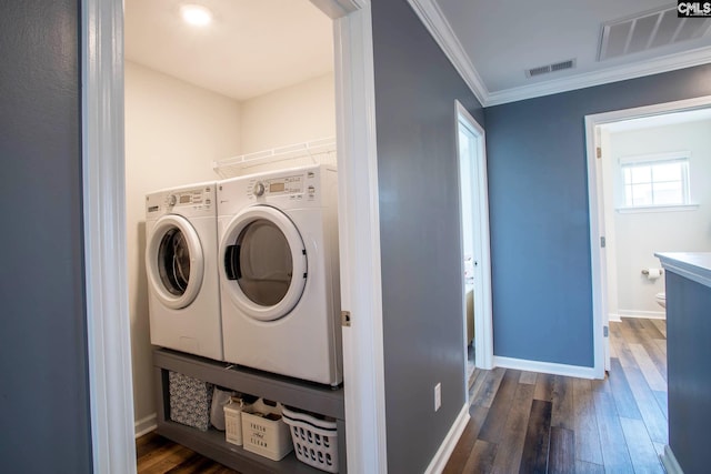 laundry area featuring dark hardwood / wood-style floors, crown molding, and independent washer and dryer