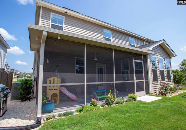 back of house with a lawn and a patio