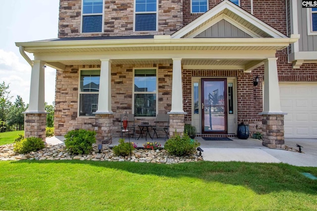 doorway to property with a porch, a garage, and a lawn