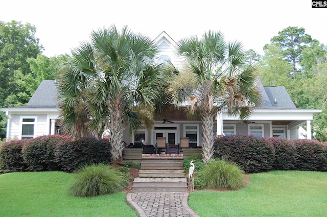 view of front facade with a front yard and french doors