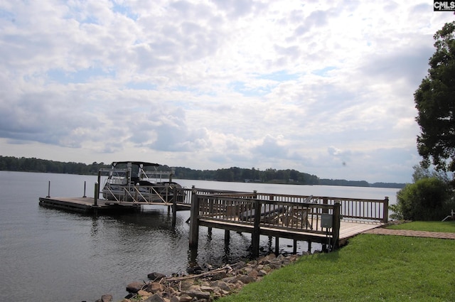 dock area with a water view and a yard