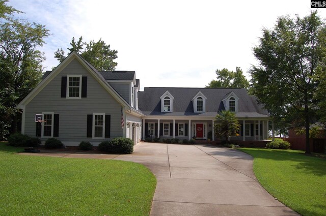 cape cod house featuring a front yard