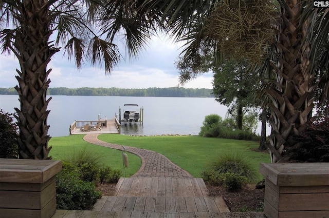 view of nearby features with a boat dock, a water view, and a yard