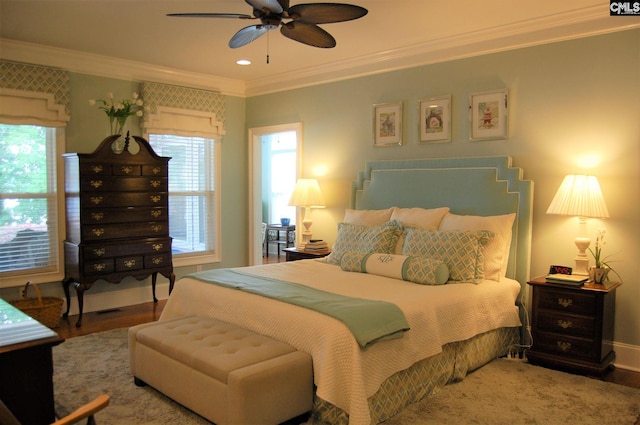 bedroom featuring ceiling fan, ornamental molding, and hardwood / wood-style flooring