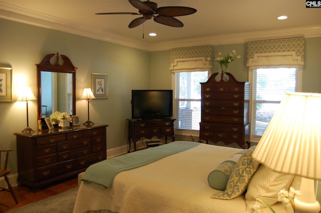 bedroom featuring ceiling fan, ornamental molding, and dark hardwood / wood-style flooring