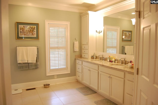 bathroom with oversized vanity, a healthy amount of sunlight, and tile floors