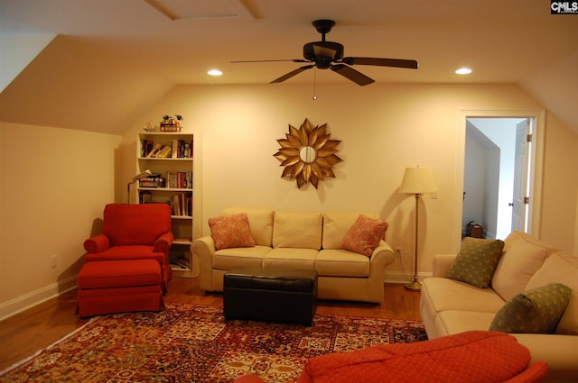 living room featuring ceiling fan, dark hardwood / wood-style floors, and vaulted ceiling