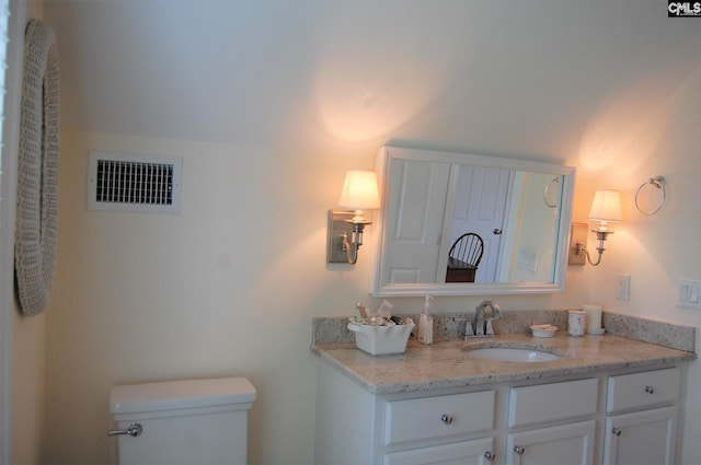 bathroom with toilet and vanity