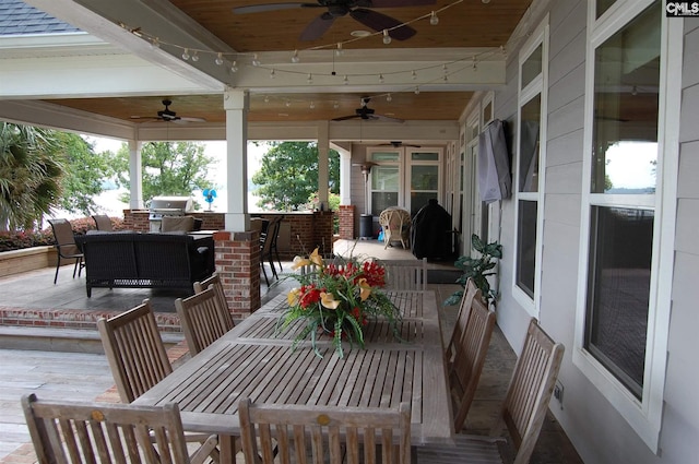 exterior space featuring a grill, ceiling fan, an outdoor kitchen, and an outdoor living space