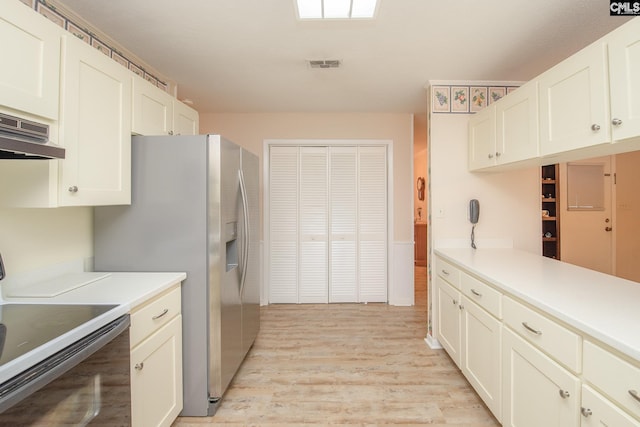 kitchen featuring stove, white cabinetry, custom exhaust hood, and light wood-type flooring