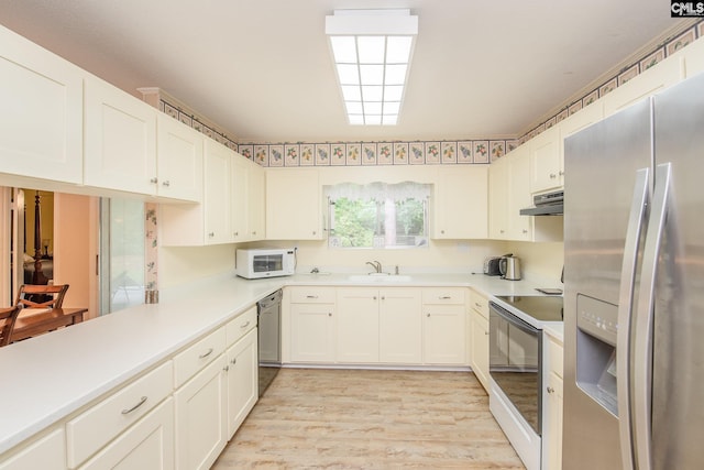 kitchen featuring white cabinetry, light hardwood / wood-style flooring, appliances with stainless steel finishes, and sink