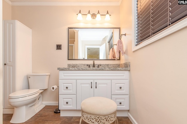 bathroom featuring crown molding, tile flooring, toilet, and vanity