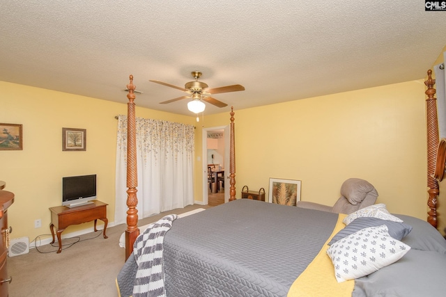 carpeted bedroom with a textured ceiling and ceiling fan