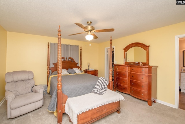 bedroom featuring ceiling fan, a textured ceiling, and light colored carpet