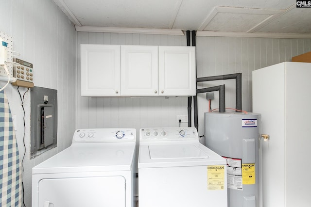 laundry area featuring washing machine and clothes dryer, cabinets, electric water heater, and ornamental molding