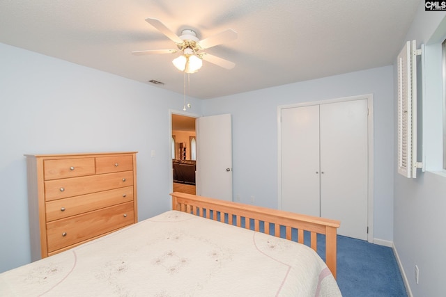 carpeted bedroom with ceiling fan and a closet