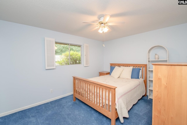 carpeted bedroom with ceiling fan and a textured ceiling