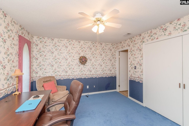 home office with light carpet, a textured ceiling, and ceiling fan