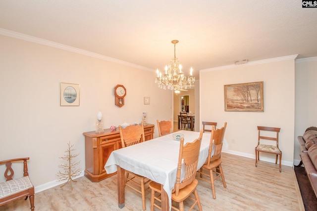 dining area with a chandelier, ornamental molding, and light hardwood / wood-style floors