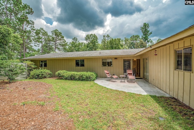 back of house with a yard and a patio area