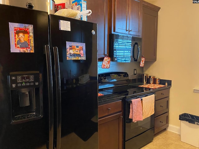 kitchen with light tile floors and black appliances