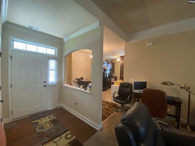 entrance foyer featuring dark hardwood / wood-style flooring and ornamental molding