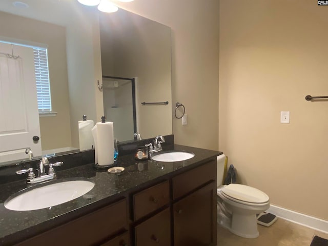 bathroom featuring tile floors, toilet, and double vanity