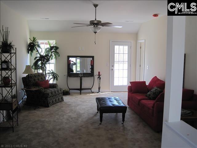 living room featuring ceiling fan and carpet