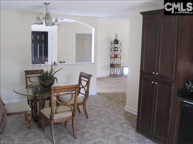 dining area featuring an inviting chandelier and light tile floors