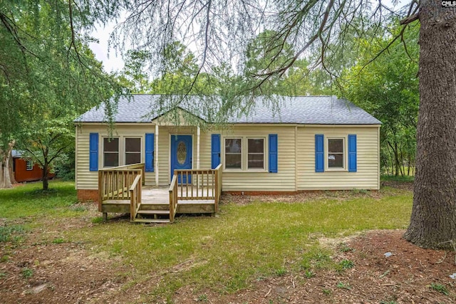 view of front facade with a deck and a front yard