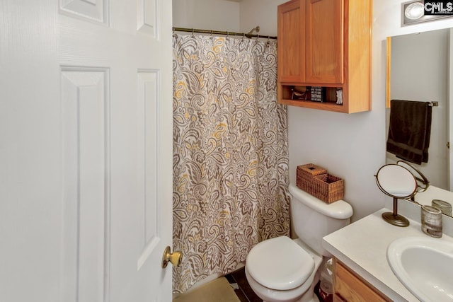 bathroom with toilet and large vanity