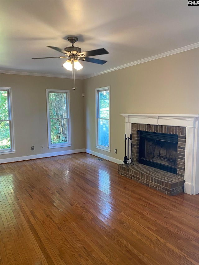 unfurnished living room with ceiling fan, dark wood-type flooring, a fireplace, and plenty of natural light