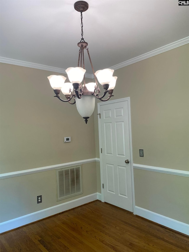 interior space featuring crown molding, dark hardwood / wood-style floors, and a notable chandelier