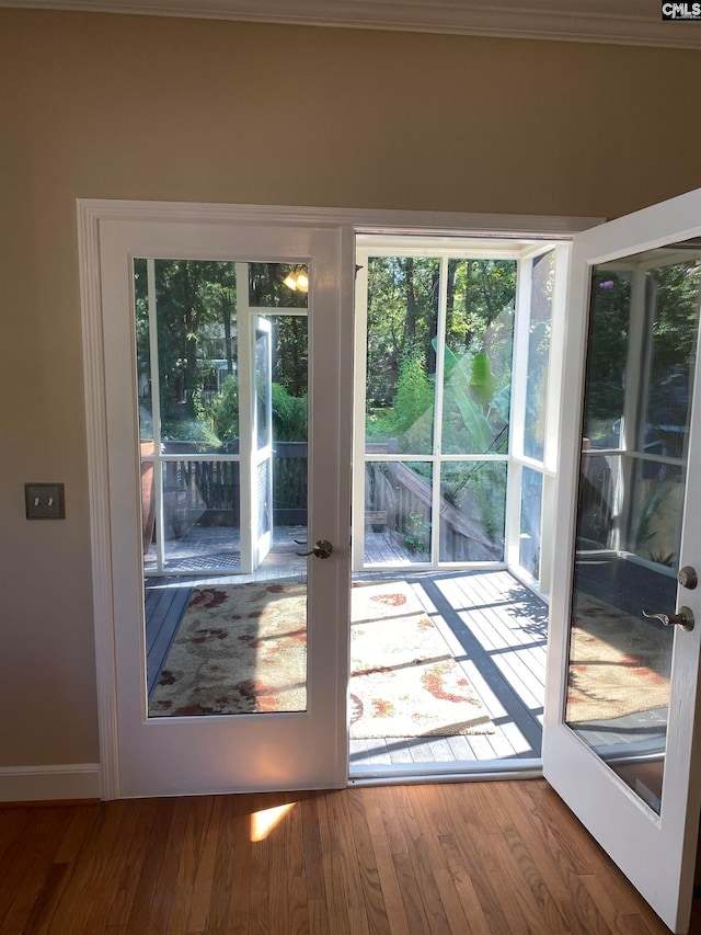 entryway featuring wood-type flooring and french doors