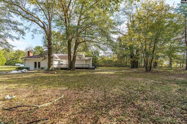 view of yard featuring a wooden deck