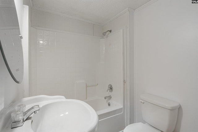 full bathroom with shower / washtub combination, toilet, a textured ceiling, and sink