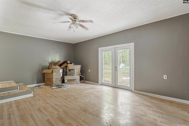 unfurnished office featuring ceiling fan, a textured ceiling, light wood-type flooring, and french doors