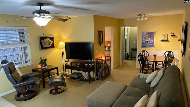 living room featuring light colored carpet, ceiling fan, and track lighting