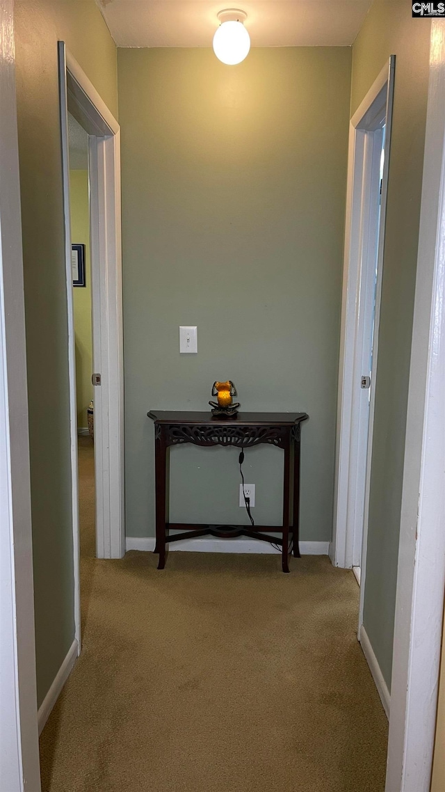 hallway featuring light colored carpet