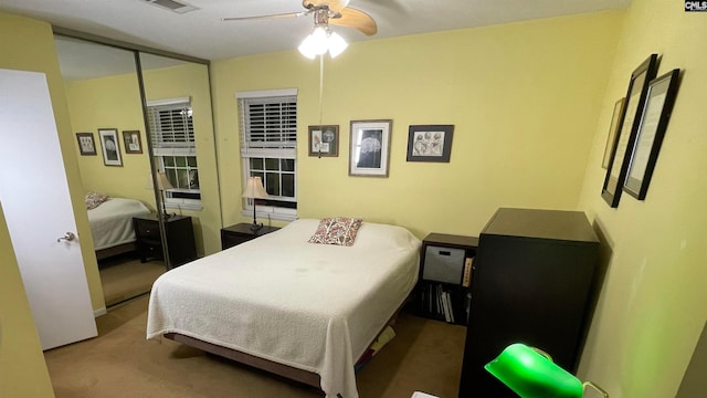 carpeted bedroom featuring a closet and ceiling fan