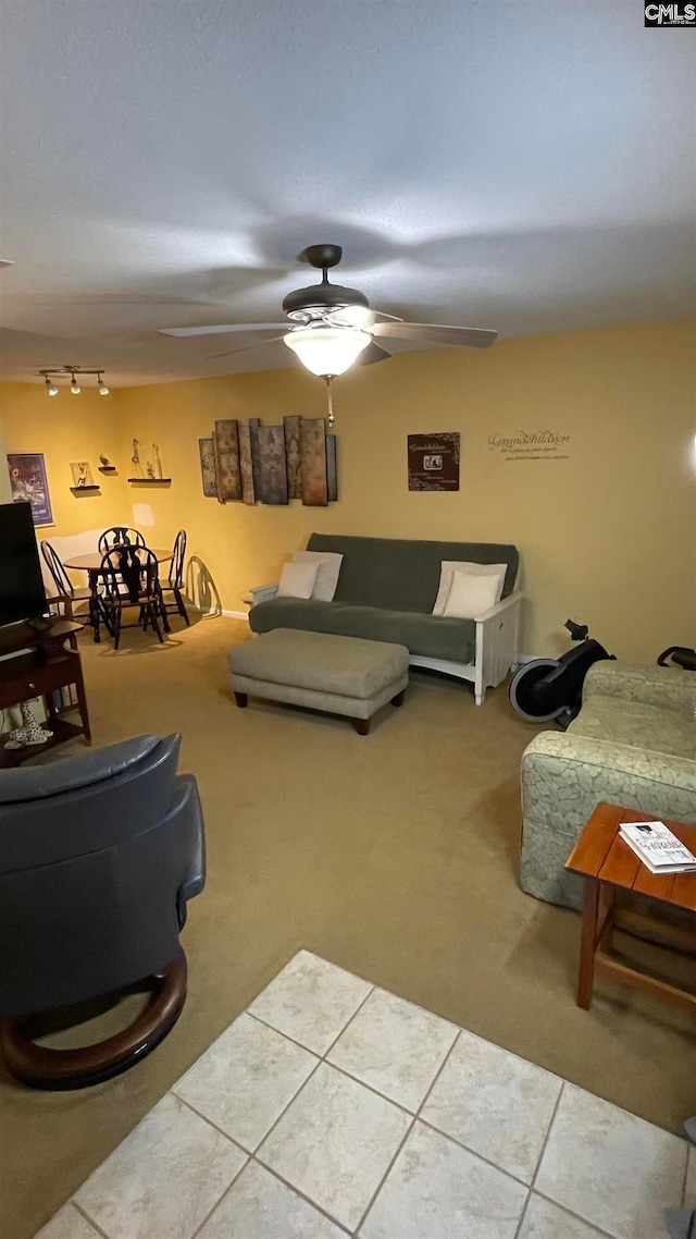 tiled living room with ceiling fan and rail lighting