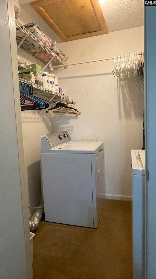 laundry area with washing machine and dryer and light carpet