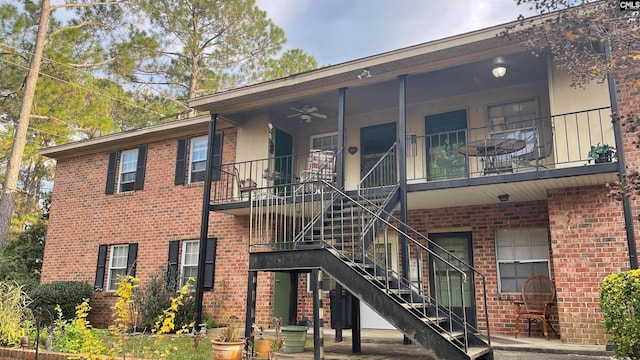 exterior space with a balcony and ceiling fan