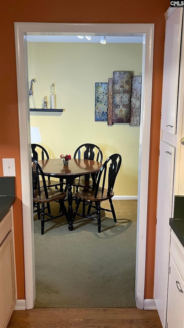 dining space with wood-type flooring