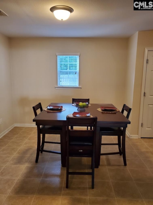 dining room with dark tile flooring