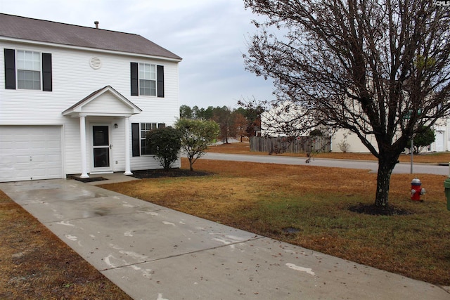 view of front of house with a front lawn and a garage